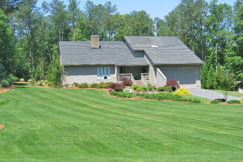 freshly mowed lawn and maintained garden in front of home