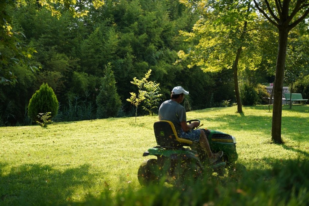 man riding John Deere mower